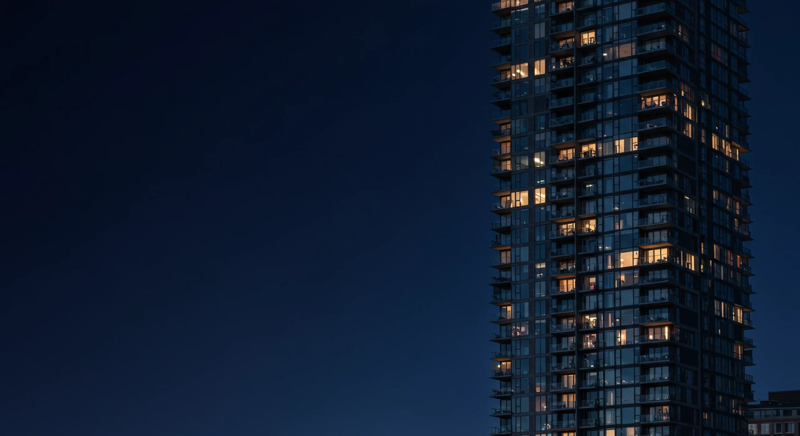 Glass condo tower at twilight